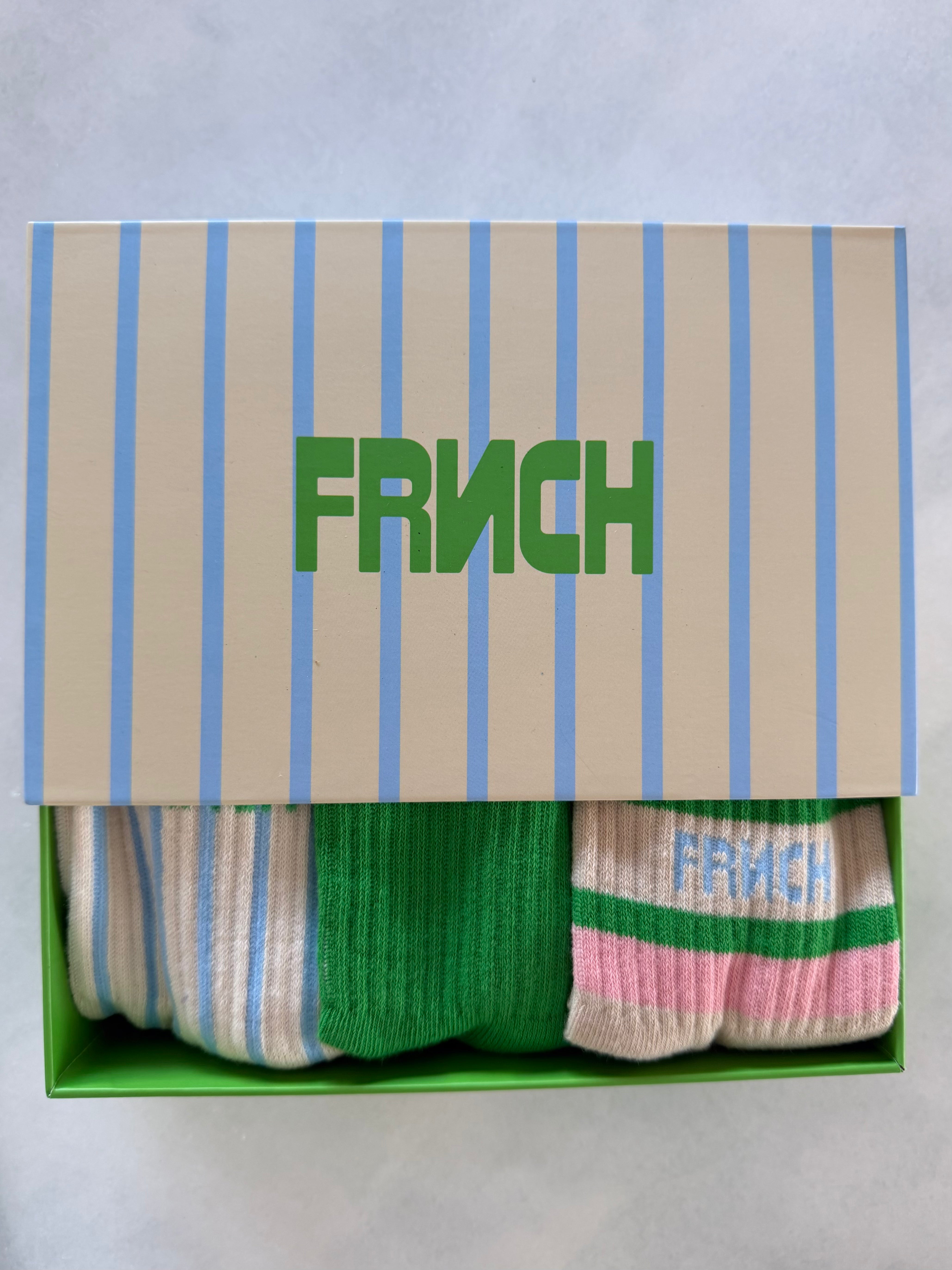 Box of socks with 'FRINCH' branding on a light gray background. FRNCH Tethy Socks Set